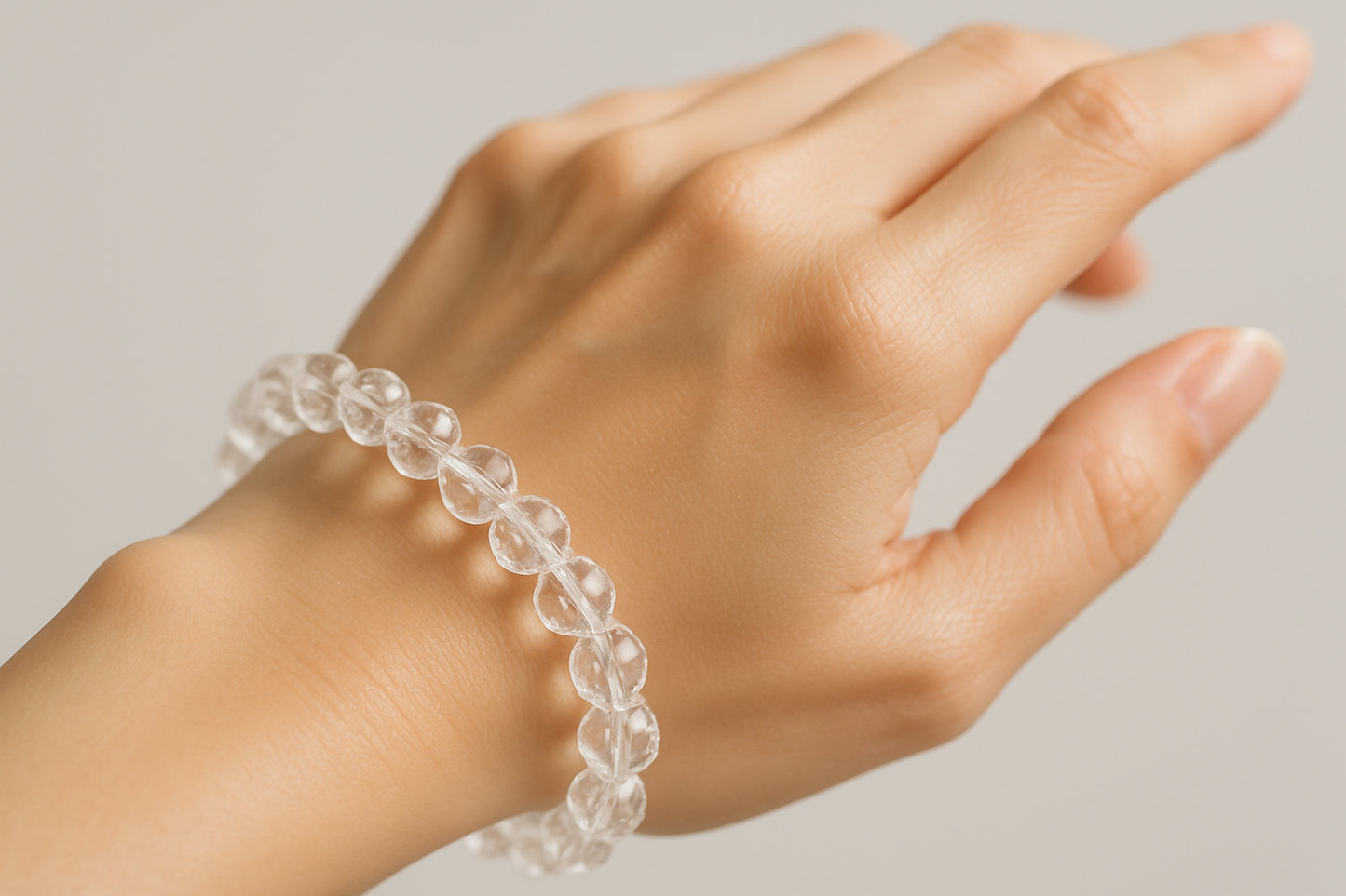 Clear Quartz Faceted Bracelet In Round Beads in women's hand HD Quality image 